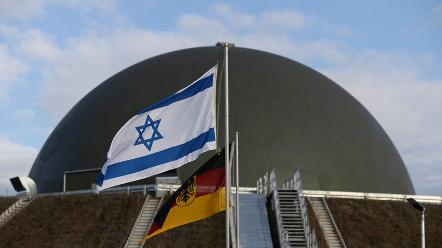 Flags flutter in front of a radom of the "Arrow Weapon System for Germany" pictured in Annaburg, Germany, December 3, 2025. REUTERS/Axel Schmidt