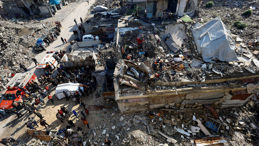 People gather during a search and rescue operation at the site of a house that was partially destroyed during the war and collapsed on Tuesday, at Shati refugee camp in Gaza City, December 16, 2025. REUTERS/Mahmoud Issa
