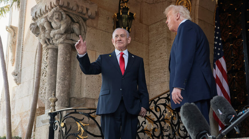 Israeli Prime Minister Benjamin Netanyahu gestures as he is welcomed by U.S. President Donald Trump for meetings at the Mar-a-Lago club in Palm Beach, Florida, U.S., December 29, 2025. REUTERS/Jonathan Ernst