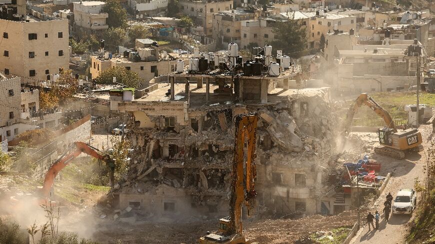 A residential building is demolished in east Jerusalem, where Israeli officials say they are targeting what they describe as unauthorised construction