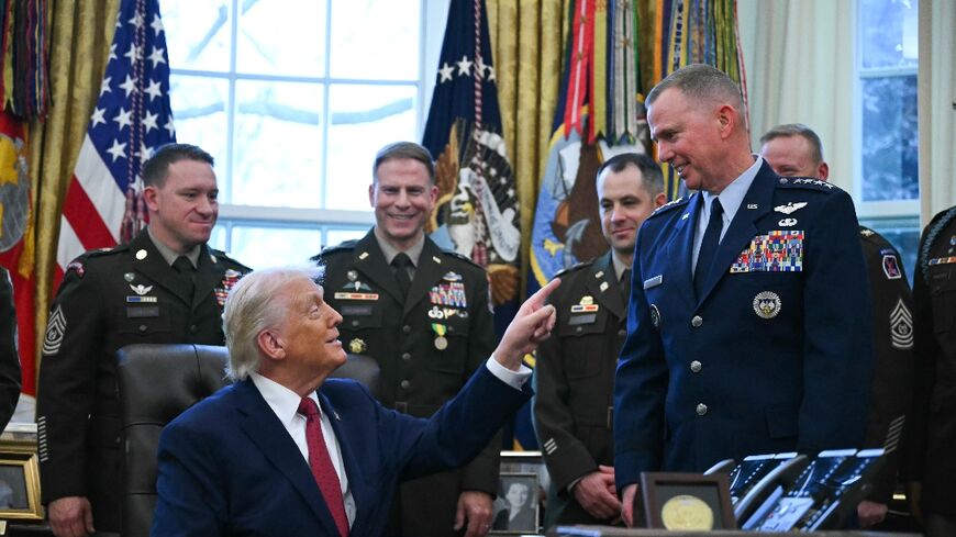 US President Donald Trump speaks with military officers at the White House