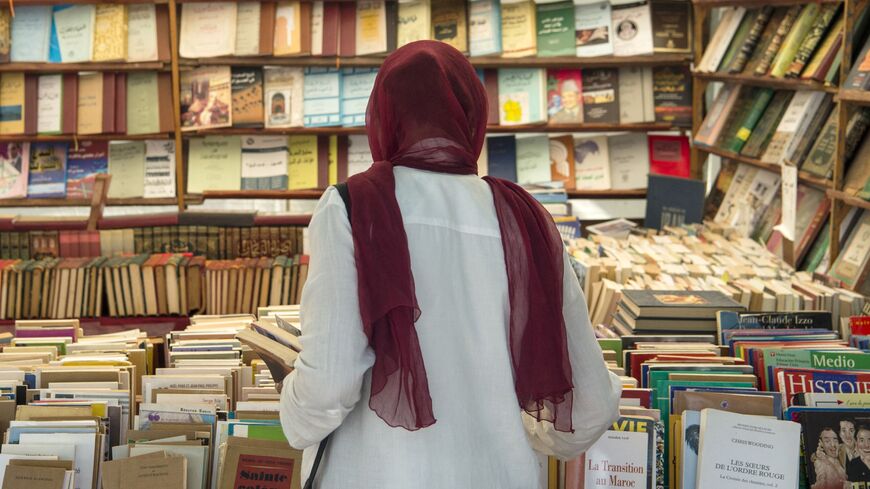 A customer browses books at a bookshop in the Moroccan capital Rabat on August 9, 2018. On the main arteries of old Rabat, dozens of itinerant booksellers offer books in French, Arabic, and sometimes in English, up to ten times cheaper than their originals. Despite being prohibited, the pirated-books market is largely tolerated in cities across the North African kingdom. (Photo by FADEL SENNA / AFP) (Photo by FADEL SENNA/AFP via Getty Images)