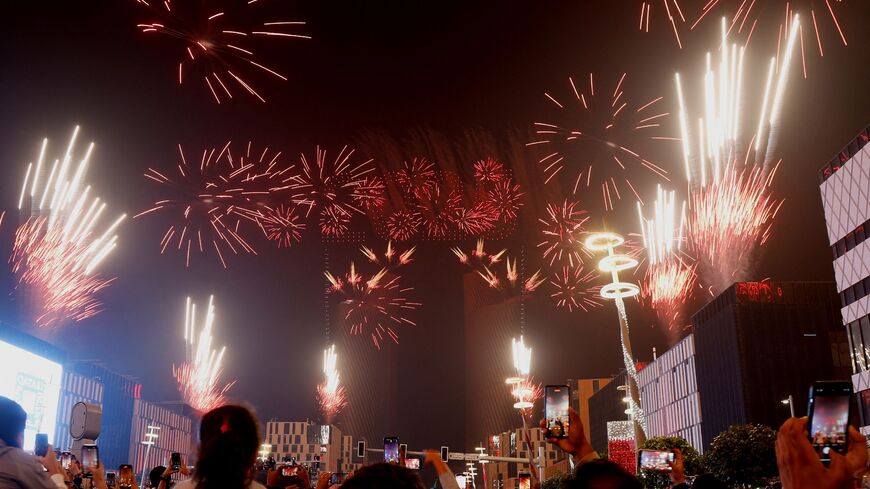 People gather to watch a fireworks and drone display during New Year's Eve celebrations in Doha early on Jan. 1, 2025. (KARIM JAAFAR/AFP via Getty Images)