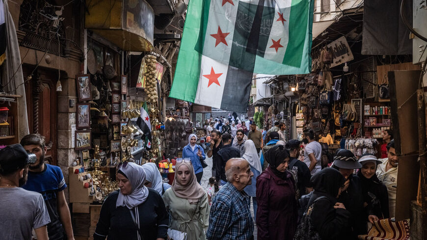 People shop in a market on June 17, 2025 in Damascus, Syria. 