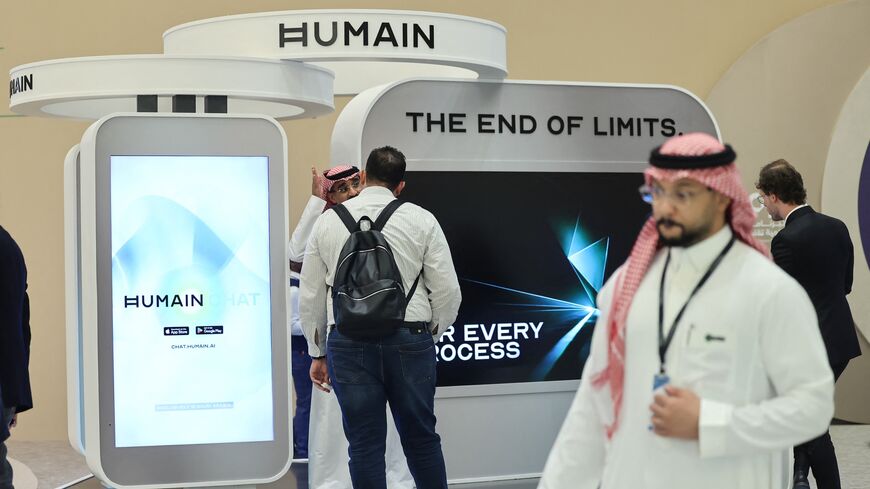 Guests stand at the booth of Saudi AI company Humain during the Future Investment Initiative conference in Riyadh on Oct. 29, 2025.