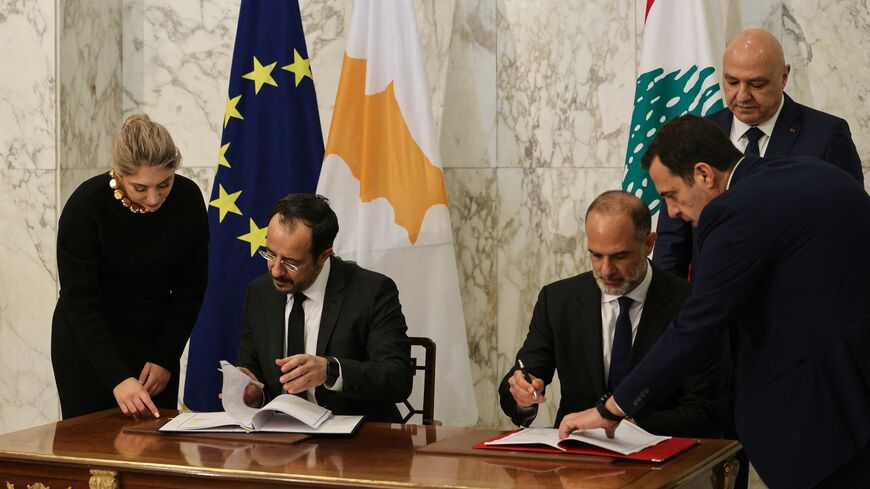 Cypriot President Nikos Christodoulides signs documents with Lebanese Minister of Public Works and Transport Fayez Rasamny, as Lebanon's president, Joseph Aoun, looks on during an agreement signing ceremony at the presidential palace of Baabda, east of Beirut, on Nov. 26, 2025. 