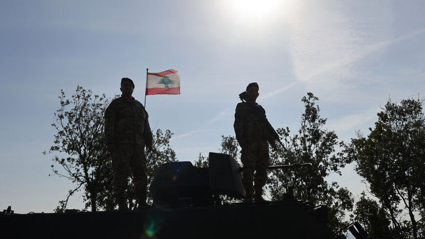This photograph taken during a press tour organised by the Lebanese army shows Lebanese soldiers standing atop a military vehicle in Alma Al-Shaab, near the border with Israel in southern Lebanon, on November 28, 2025. It was the first guided tour the army gave journalists since a November 2024 ceasefire sought to end over a year of hostilities between Hezbollah and Israel. (Photo by Anwar AMRO / AFP via Getty Images)