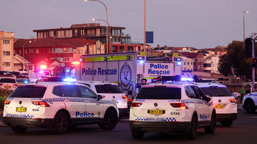 Police vehicles are seen on a road after a shooting incident at Bondi Beach in Sydney on Dec. 14, 2025. 