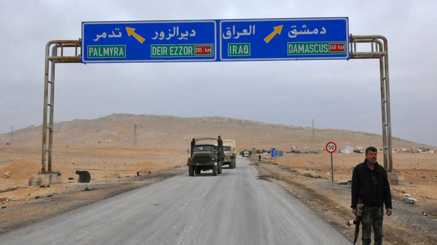 A picture taken on March 2, 2017, shows a sign displaying the routes to Palmyra-Deir Ezzor and Damascus-Iraq as Syrian regime fighters advance to retake the ancient city of Palmyra, from Islamic State (IS) group fighters. / AFP PHOTO / STRINGER (Photo credit should read STRINGER/AFP via Getty Images)