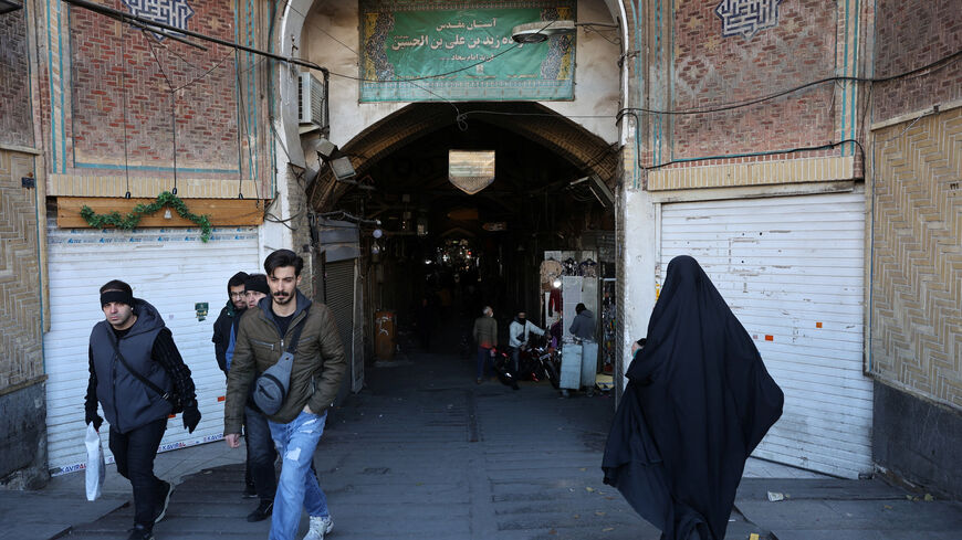 People walk past closed shops following protests over a plunge in the currency's value, in the Tehran Grand Bazaar in Tehran, Iran, December 30, 2025. Majid Asgaripour/WANA (West Asia News Agency) via REUTERS