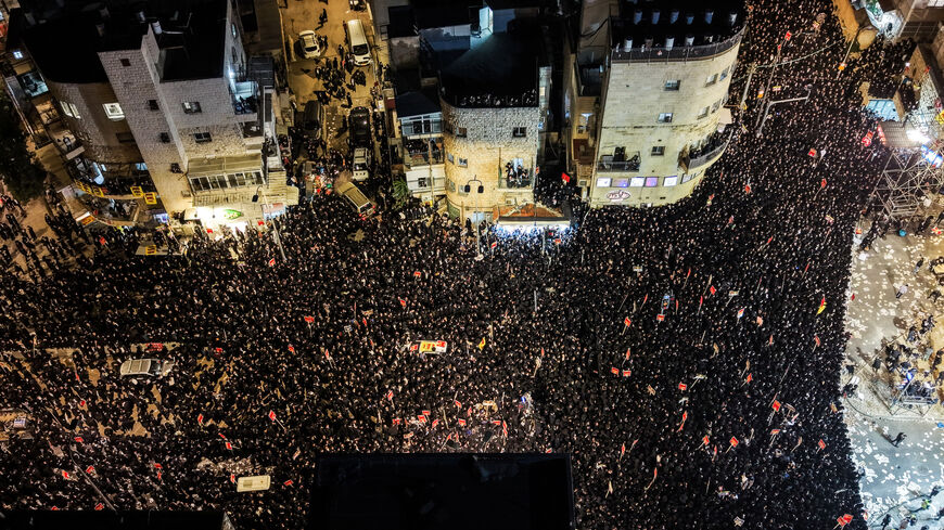 A drone view shows Ultra-Orthodox Jewish men as they protest against pressure to conscript men from their community into Israel's military, in Jerusalem, January 6, 2026.   REUTERS/Ilan Rosenberg