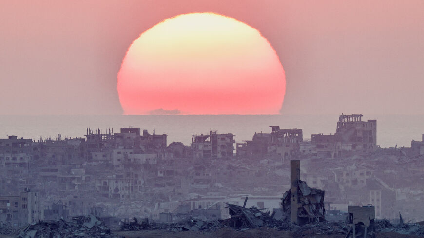 The sun sets over north Gaza, as seen from the Israeli side of the border, July 28, 2025. REUTERS/Amir Cohen