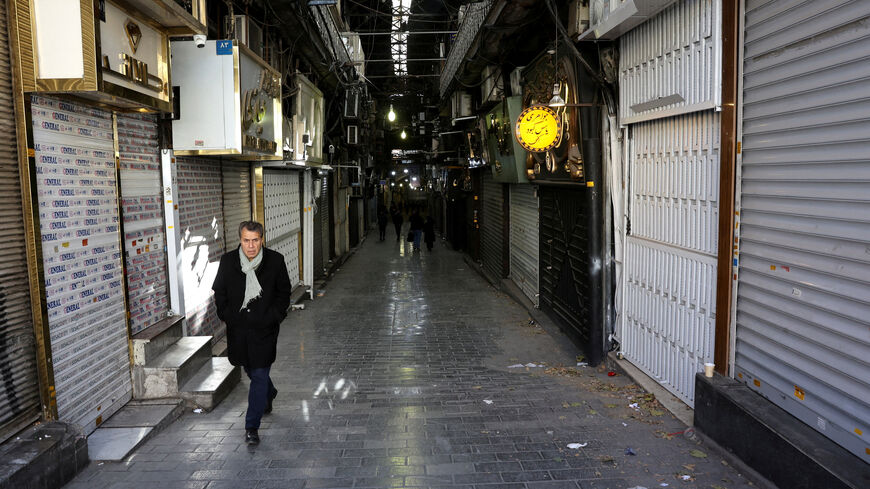 FILE PHOTO: People walk past closed shops following protests over a plunge in the currency's value, in the Tehran Grand Bazaar, Tehran, Iran, December 30, 2025. Majid Asgaripour/WANA (West Asia News Agency) via REUTERS/File Photo