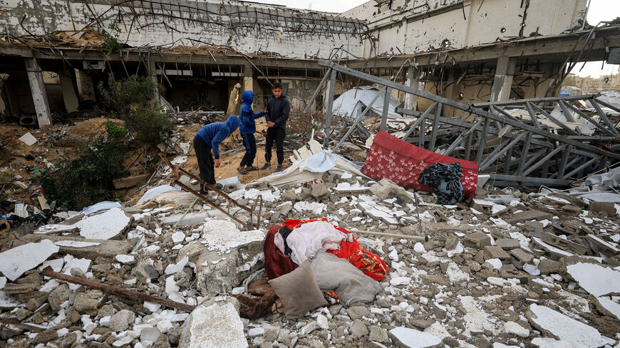 Palestinians inspect the damage at the site of a war-damaged building after parts of it collapsed, on a windy winter day, in Gaza City, January 13, 2026. REUTERS/Dawoud Abu Alkas