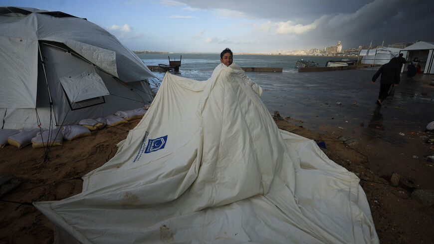 A displaced Palestinian stands with a collapsed tent, due to a weather disturbance in Gaza City, January 9, 2026. REUTERS/Dawoud Abu Alkas