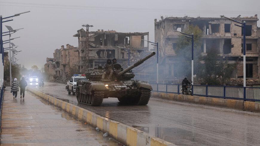 Military personnel sit on top of a tank, after the Syrian Democratic Forces (SDF) withdrew from Deir al-Zor province and the Syrian army took full control over the area, in Deir al-Zor, Syria, January 18, 2026. REUTERS/Khalil Ashawi