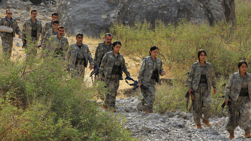 Fighters with the Kurdistan Workers' Party (PKK) walk for a disarmament ceremony marking a significant step toward ending the decades-long conflict between Turkey and the outlawed group, in the Qandil mountains, Iraq October 26, 2025. REUTERS/Thaier Al-Sudani