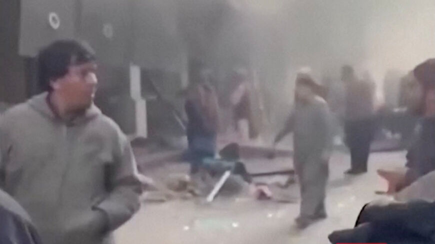 People gather amid smoke near the site following a blast at a Chinese-run restaurant, in Kabul, Afghanistan, January 19, 2026 in this screengrab taken from a handout video.  TOLOnews via FACEBOOK/Handout via REUTERS