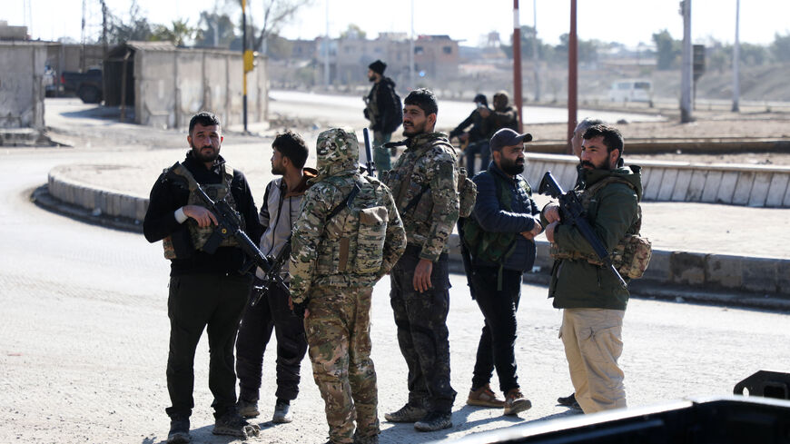 Syrian Democratic Forces (SDF) fighters stand guard, following clashes between SDF and Syrian government forces, in Hasakah, Syria, January 20, 2026. REUTERS/Orhan Qereman