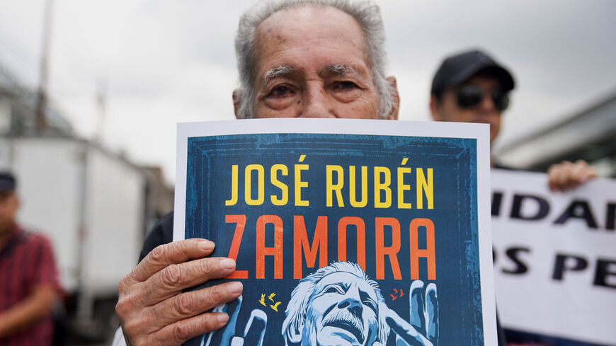 A man holds a sign with an image depicting journalist Jose Ruben Zamora during a protest to demand his release from jail, in Guatemala City, Guatemala, September 18, 2025. REUTERS/Cristina Chiquin/File Photo