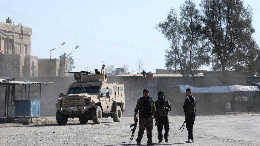 Syrian Democratic Forces (SDF) fighters walk near an armored vehicle, following clashes between SDF and Syrian government forces, in Hasakah, Syria, January 20, 2026. REUTERS/Orhan Qereman