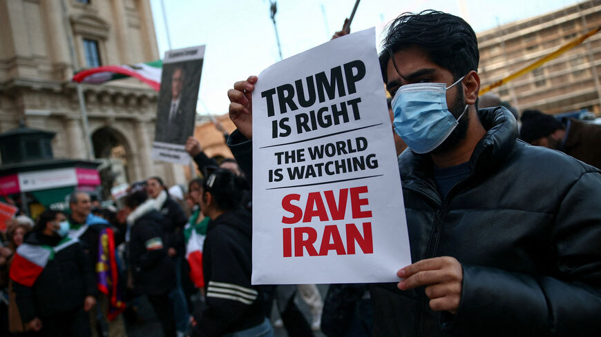 FILE PHOTO: A man shows a sign mentioning U.S. President Donald Trump during a rally in support of nationwide protests in Iran, in Rome, Italy, January 13, 2026. REUTERS/Francesco Fotia/File Photo
