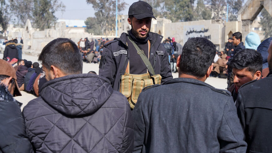 Members of the Kurdish-led Syrian Democratic Forces (SDF) queue to settle their status with Syrian government in Raqqa, Syria January 27, 2026. REUTERS/Karam al-Masri