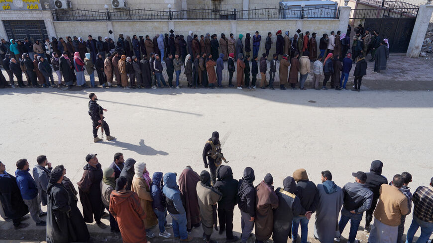 FILE PHOTO: Members of the Kurdish-led Syrian Democratic Forces (SDF) queue to settle their status with Syrian government in Raqqa, Syria January 27, 2026. REUTERS/Karam al-Masri/ File Photo