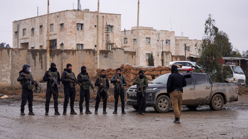 Syrian security forces stand guard outside al-Aqtan prison, where some Islamic State detainees are held, in Raqqa, Syria January 23, 2026. REUTERS/Karam al-Masri