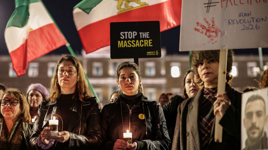 Amnesty International Greek activists and Iranians living in Athens hold candles and placards in front of the Greek Parliament to support the people of Iran, in Athens, Greece, January 30, 2026. REUTERS/Louisa Gouliamaki     TPX IMAGES OF THE DAY