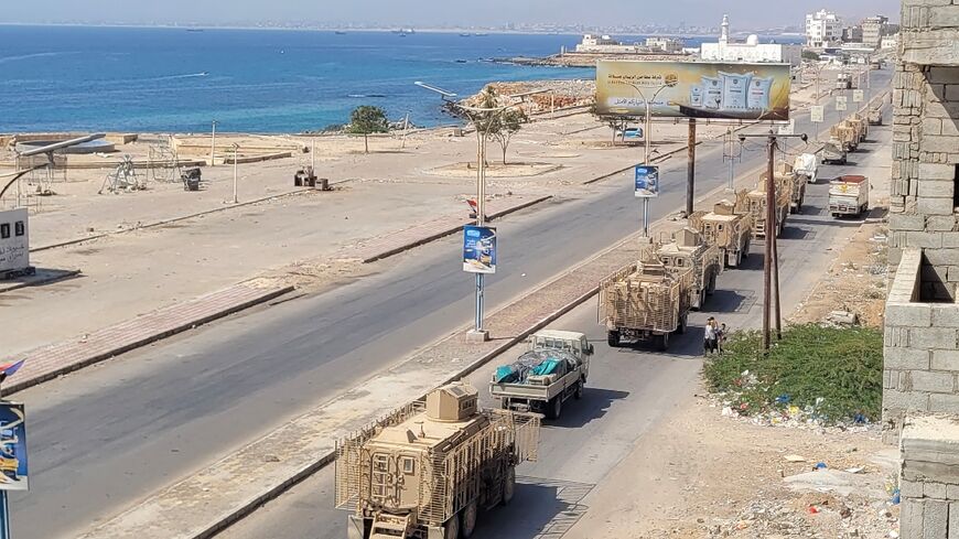 A convoy of armoured vehicles makes its way along a street in southern Yemen on January 1