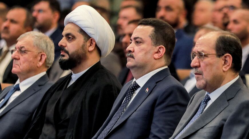 (L to R) Iraqi President Abdul Latif Rashid; Qais al-Khazali, head of the "Asaib Ahl al-Haq"; one of the member factions of the Hashd al-Shaabi (Popular Mobilization Forces) paramilitaries; Prime Minister Mohammed Shia al-Sudani; and former Prime Minister Nuri al-Maliki attend an event commemorating the 21st anniversary of the group's creation at a hotel in Baghdad on May 3, 2024.