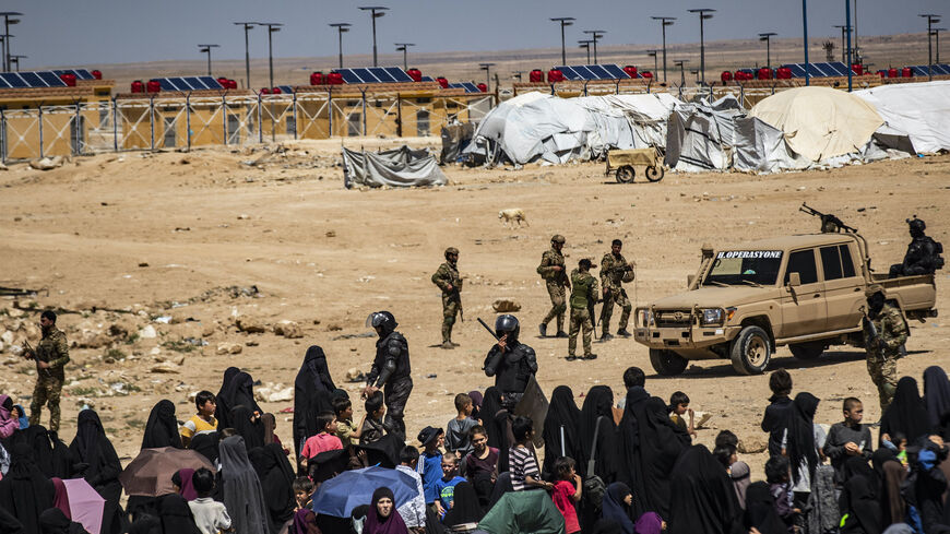 Members of the Syrian Kurdish Asayish security forces gather at the Kurdish-run al-Hol camp, which holds relatives of suspected Islamic State (IS) group fighters in the northeastern Hasakeh governorate, on April 18, 2025, as the Syrian Democratic Forces mount a security campaign against IS "sleeper cells" in the camp.