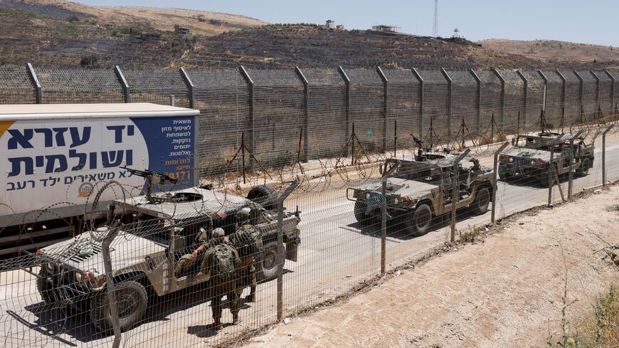 Israel military vehicles drive along the border fence into Israel, near the town of Majdal Shams, in the Israeli-annexed Golan Heights, on July 17, 2025. Syrian government forces have withdrawn from the whole of Sweida province after days of sectarian bloodshed in the heartland of the Druze minority, a war monitor and witnesses said July 17, 2025. (Photo by Jalaa MAREY / AFP) (Photo by JALAA MAREY/AFP via Getty Images)