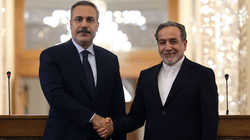 Iran's Foreign Minister Abbas Araghchi (R) shakes hands with Turkey's Foreign Minister Hakan Fidan during press conference in Tehran on Nov. 30, 2025. 