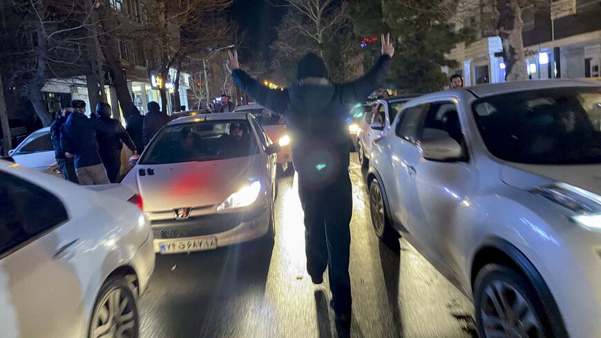 A protester flashes victory signs as traffic slows during demonstrations in Hamedan, Iran, on Jan. 1, 2026. 
