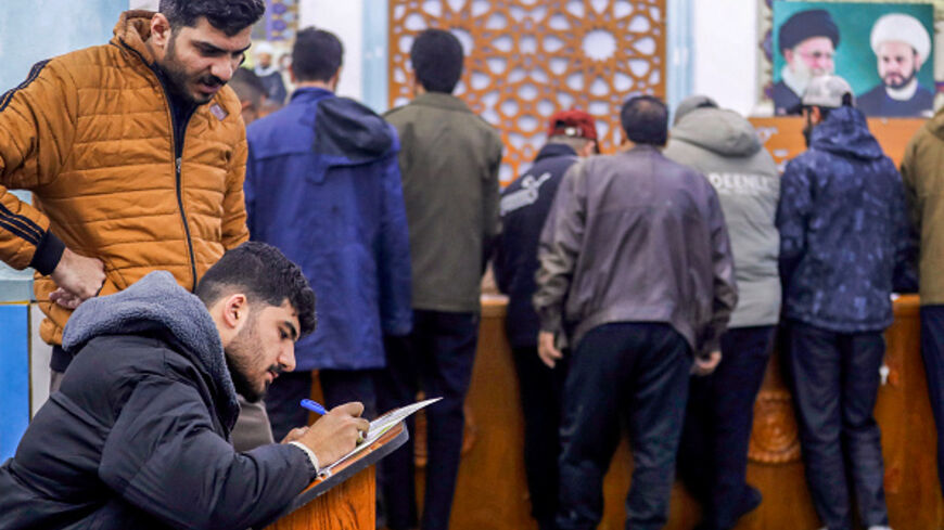 Men sign up to join the "martyrdom brigades" under the umbrella of Iraq's pro-Iran paramilitary group Hezbollah Brigades (Kataib Hezbollah), who called upon Iraqis to volunteer in fighting alongside Iran in the event of a full-scale war with the US and Israel, at a mosque in Baghdad on January 29, 2026. (Photo by AHMAD AL-RUBAYE / AFP via Getty Images)
