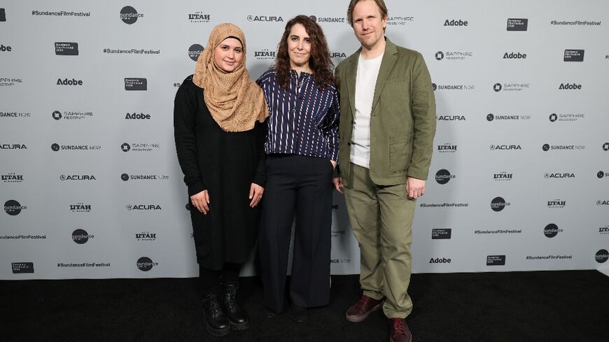 Syrian refugee Isra’a (L) stands alongside directors Itab Azzam and Jack MacInnes at the "One In A Million" premiere during the 2026 Sundance Film Festival