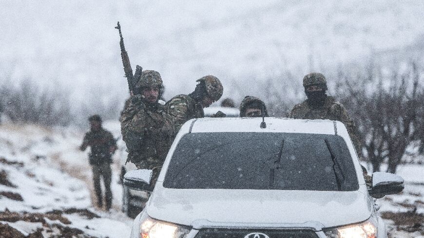 Syrian soldiers make their way through the country's mountainous Qalamoun region, near the border with Lebanon, on January 1, 2026