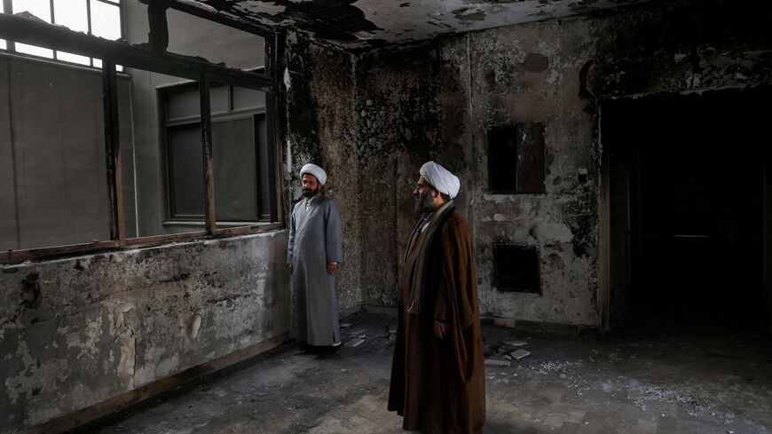 FILE PHOTO: Iranian clerics stand in the Islamic seminary that was burned during Iran's protests, in Tehran, Iran, January 21, 2026. Majid Asgaripour/WANA (West Asia News Agency) via REUTERS