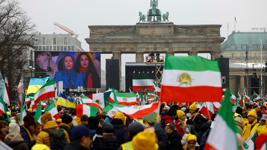 Demonstrators watch on screen Iranian opposition leader Maryam Rajavi speaking on stage, during a protest organized by supporters of the Iranian opposition group, the National Council of Resistance of Iran, to demand an immediate stop to the violence against protesters in Iran and an end to detentions and repression, in Berlin, Germany, February 7, 2026. REUTERS/Axel Schmidt