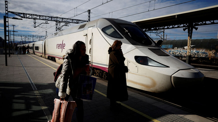 FILE PHOTO: Passengers walk past a Renfe 130 series Talgo Bombardier train at Miranda de Ebro station, Spain, February 8, 2025. REUTERS/Vincent West/File Photo