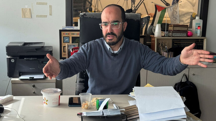 Samer Khaweireh, 45, a Palestinian journalist and former prisoner, explains the amount of food he was given daily while in Israeli detention, during an interview with Reuters in Nablus, in the Israeli occupied West Bank, February 2, 2026. Picture taken with a phone. REUTERS/Sinan Abu Mayzer