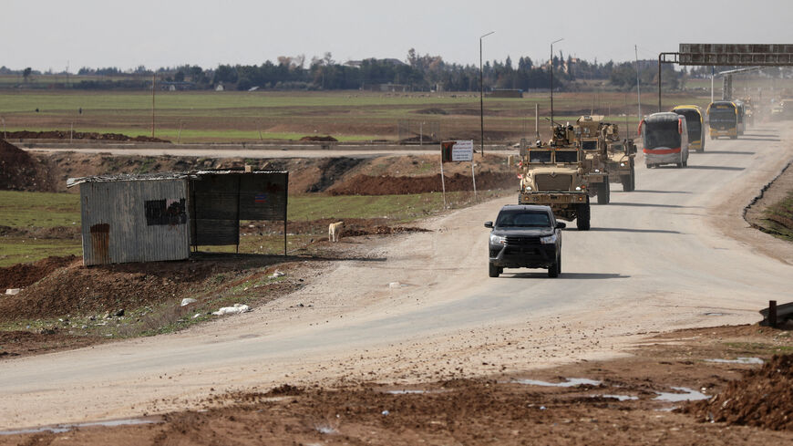 U.S. military vehicles move ahead of buses transporting Islamic State detainees from Syria to Iraq, according to a security source from the Syrian Democratic Forces, in Qamishli, Syria. REUTERS/Orhan Qereman