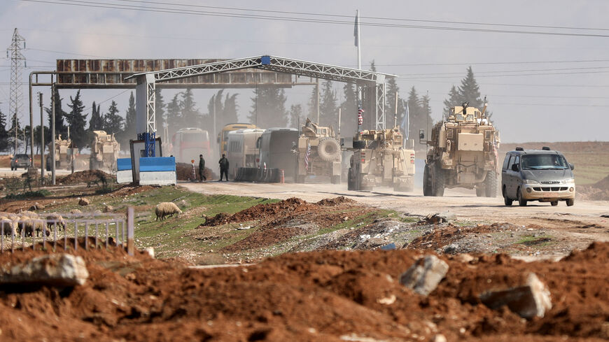 U.S. military vehicles escort buses transporting Islamic State detainees from Syria to Iraq, according to a security source from the Syrian Democratic Forces, in Qamishli, Syria, February 8, 2026. REUTERS/Orhan Qereman