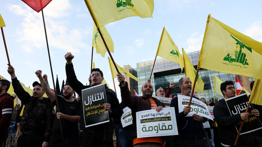 Protesters hold placards and Hezbollah flags during a demonstration condemning recent Israeli military actions in Lebanon, in Beirut, Lebanon February 4, 2026. REUTERS/Mohamed Azakir