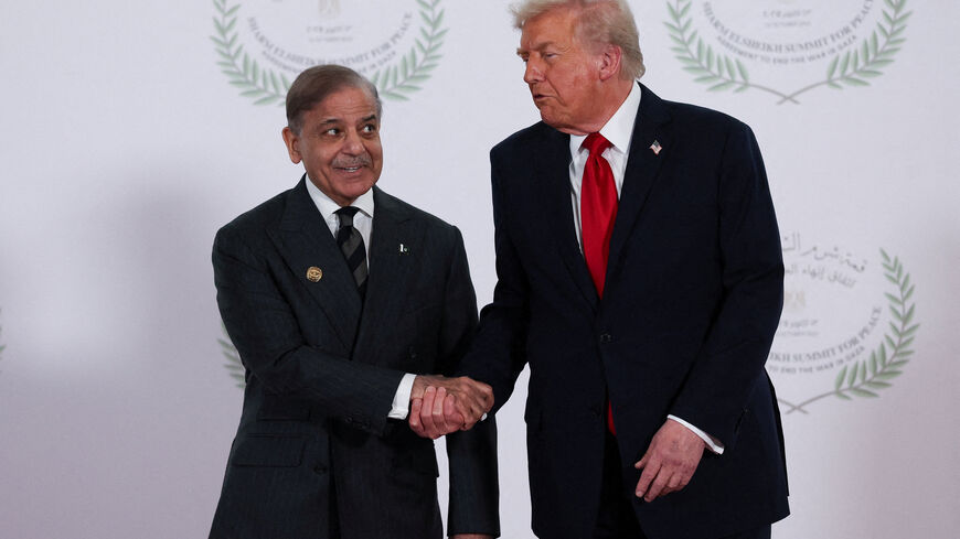 FILE PHOTO: U.S. President Donald Trump and Pakistani Prime Minister Shehbaz Sharif shake hands as they pose for a photo, at a world leaders' summit on ending the Gaza war, amid a U.S.-brokered prisoner-hostage swap and ceasefire deal between Israel and Hamas, in Sharm el-Sheikh, Egypt, October 13, 2025. REUTERS/Suzanne Plunkett/Pool/File Photo