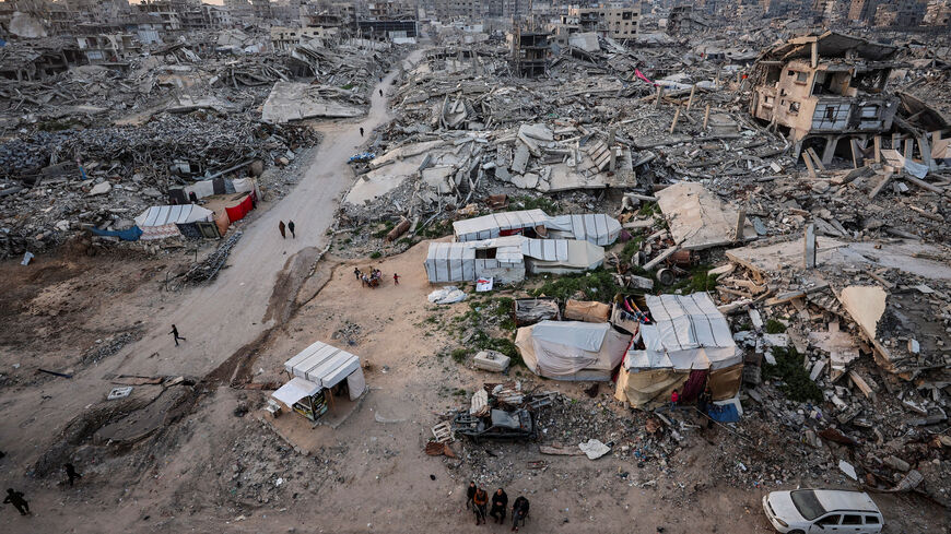 Palestinians gather near the rubble of residential buildings destroyed during the two-year Israeli offensive, on the first day of the holy month of Ramadan, in Gaza City, February 18, 2026. REUTERS/Dawoud Abu Alkas