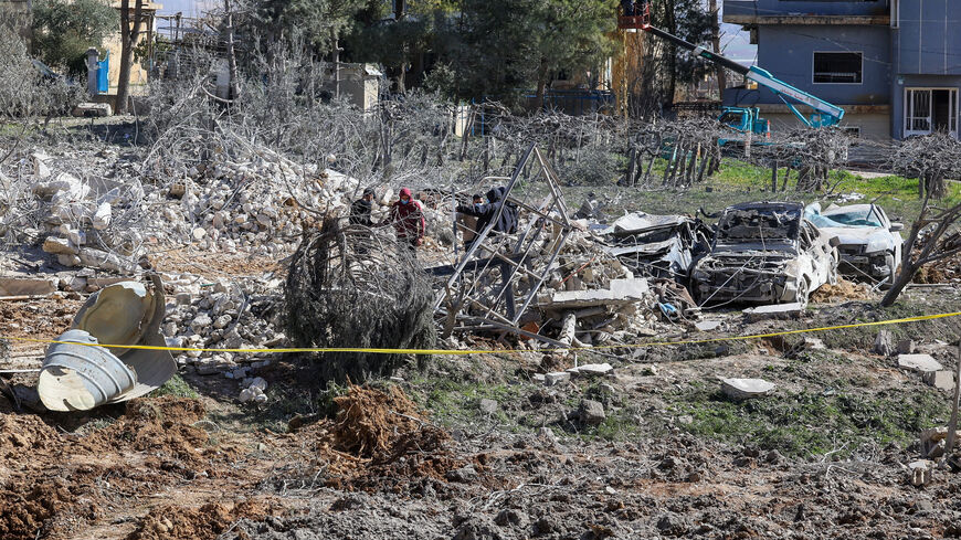 People inspect the damage at the site of an Israeli strike on Friday, in Bednayel, Bekaa valley, Lebanon, February 21, 2026. REUTERS/Mohamed Azakir