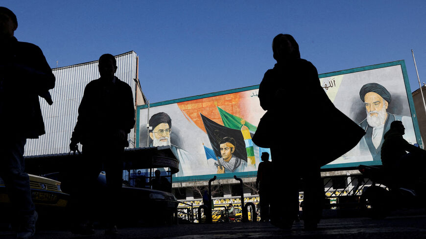 FILE PHOTO: People walk near a mural featuring images of Iran's Supreme Leader Ayatollah Ali Khamenei and leader of Iran's 1979 Islamic Revolution Ayatollah Ruhollah Khomeini, on a street in Tehran, Iran, February 17, 2026. Majid Asgaripour/WANA (West Asia News Agency) via REUTERS